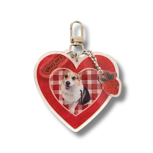 Heart-shaped keychain with a dog photo and strawberry design on a white background