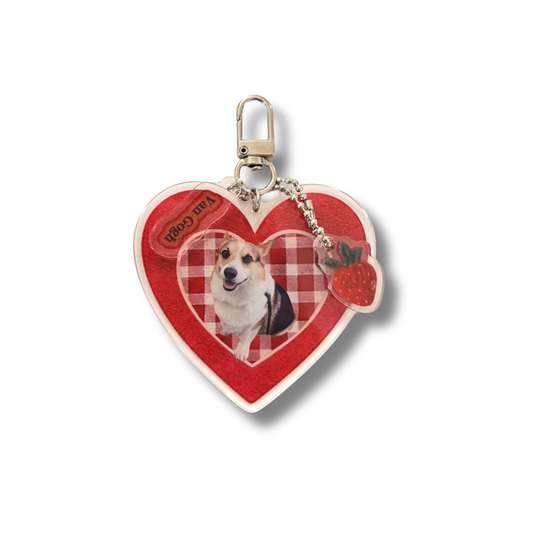 Heart-shaped keychain with a dog photo and strawberry design on a white background