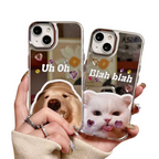 Two phone cases with a bear and cat design held by a hand.