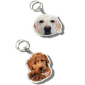 Two keychains with dog faces on a white background